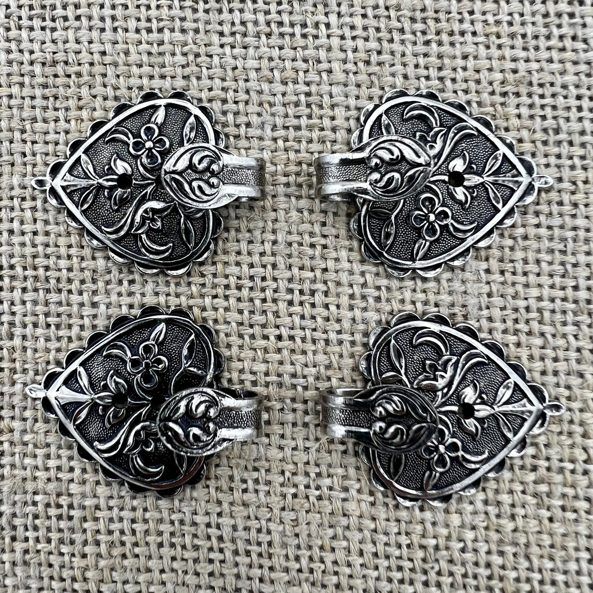 Floraler Miederhaken 7 in Altsilber mit kleinen Blumen auf der Grundplatte