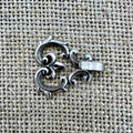 Miederhaken 18 in Altsilber mit geschwungenen Linien und rankender Rose