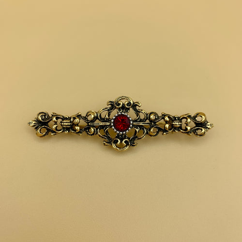 Filigrane Anstecknadel „6“ in Altmessing mit rundem Swarovski®-Kristall in Rubin