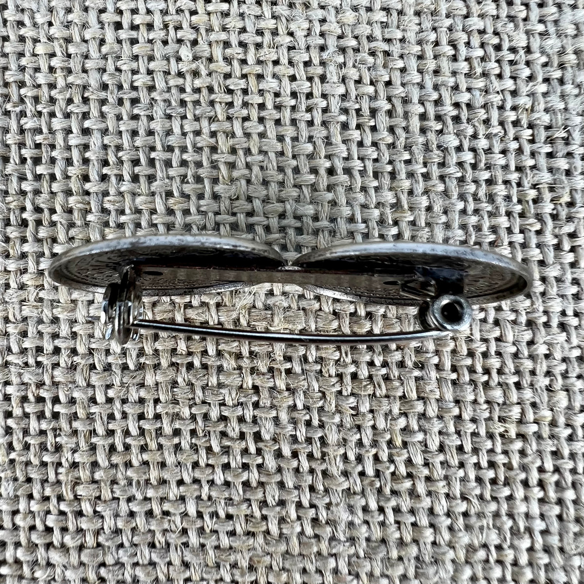 Anstecknadel mit zwei kleinen geprägten Talern in Altsilber